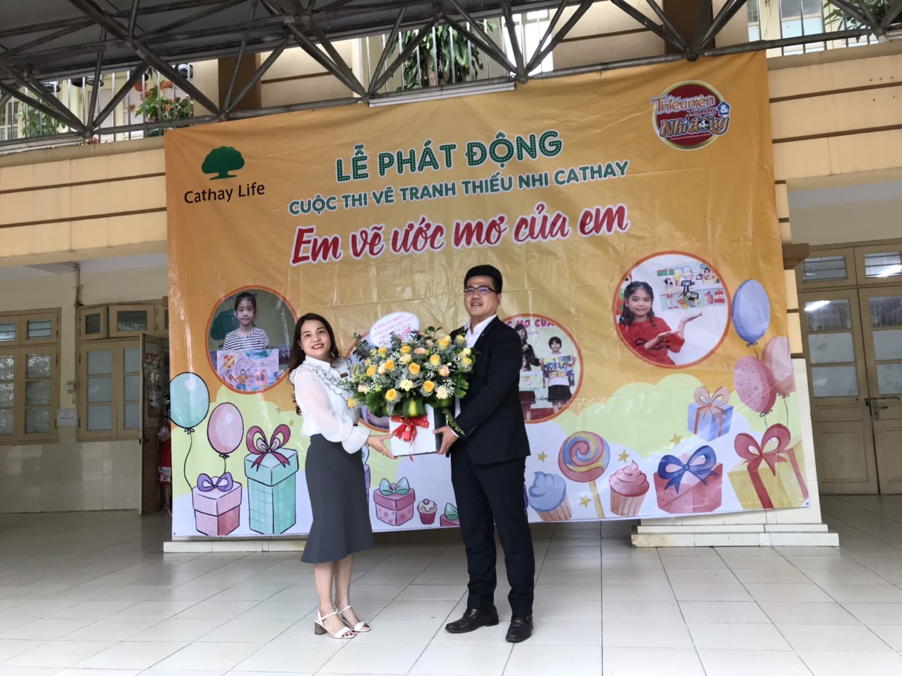 Đại diện công ty TNHH bảo hiểm Cathay tặng hoa nhà trường.